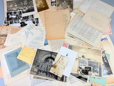 a lot of old photos and old letters on the table