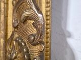 a gold frame with a picture of a woman on it