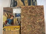two books sitting on top of a bed next to each other