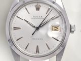 an image of a watch with a white dial and brown leather strap