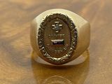 an image of a gold signet ring with a coin on it