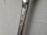 a silver spoon with a spoon handle on top of it