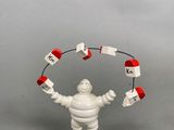a toy figure of a man holding a clock