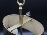 a metal object that is sitting inside of a wooden barrel
