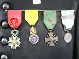 many medals and medals hanging on a black jacket