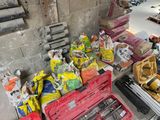 a pile of tools sitting on the floor next to a wall