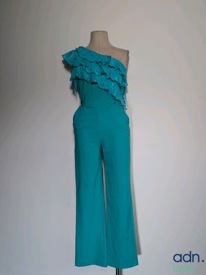 turquoise one shoulder jumpsuit with ruffles on a mannequin