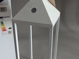 a white paper lantern with a tag on it