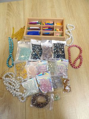 a wooden box with beads and beads on the table