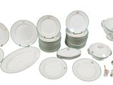 a lot of plates and bowls on the table