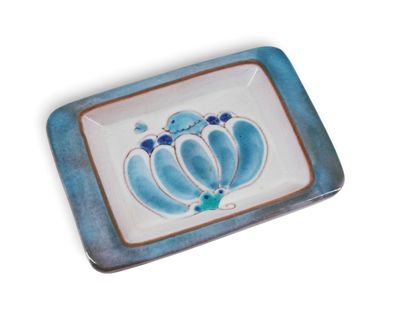 a blue and white plate with a flower design on it