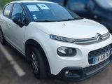 a picture of a white car parked in a parking lot