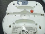 a close up of a white electrical device with a red button