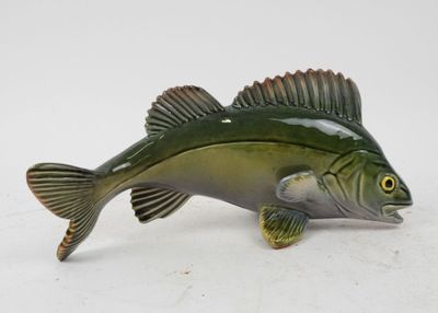 figurine of a small fish with a green body and brown fins