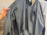 a man that is looking at some clothes on a rack