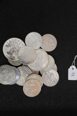 a pile of coins and a tag on a black surface