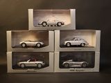 three boxes of silver model cars sitting on top of each other