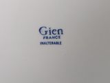 a close up of a white plate with blue writing on it