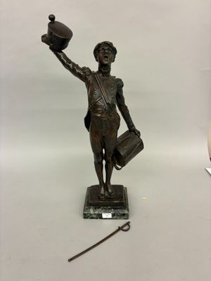 bronze statue of a woman holding a hat and a cane