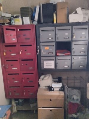 many drawers and boxes in a room with a lot of stuff