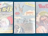 three comic books sitting on top of a table next to each other