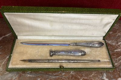 a box that has a knife, a pen and a knife in it