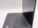 a laptop with a black keyboard on a white surface