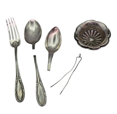 a spoon, fork, and spoon rest on a white surface