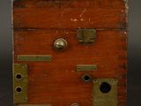 an old wooden box sitting on top of a black surface