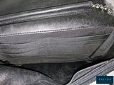 a black purse with a chain hanging out of it