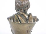 bronze bust of a boy sitting in a bowl on a marble base