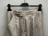 striped pants hanging on a hanger against a white wall
