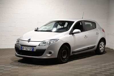 a picture of a small white car parked in a garage