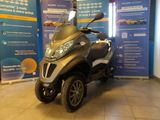 a scooter that is parked in a showroom