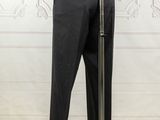 black pants on a mannequin stand in front of a white wall