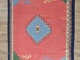 a rug hanging on a brick wall in a room