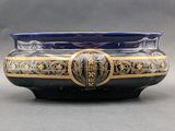 a blue and gold bowl sitting on a table