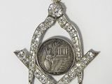 a close up of a silver medal with a coin in the center