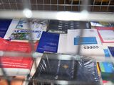 a lot of books that are in a wire basket