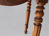 a close up of a wooden table with a drawer on top of it