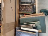 many books stacked on top of each other in a box