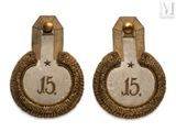 pair of gold - plated earrings with the number 15 on them