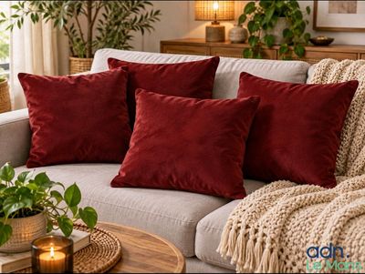 three red pillows on a couch in a living room