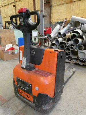 a forklift that is sitting in the middle of a warehouse