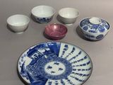 a blue and white plate and bowls on a table