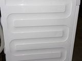 an image of a white chest freezer in a garage