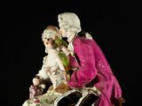 a figurine of a man and a woman sitting on a table