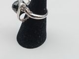 a close up of a silver ring on a black cone