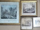 many framed pictures hanging on the wall of a room