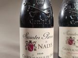 two bottles of wine sitting next to each other on a table